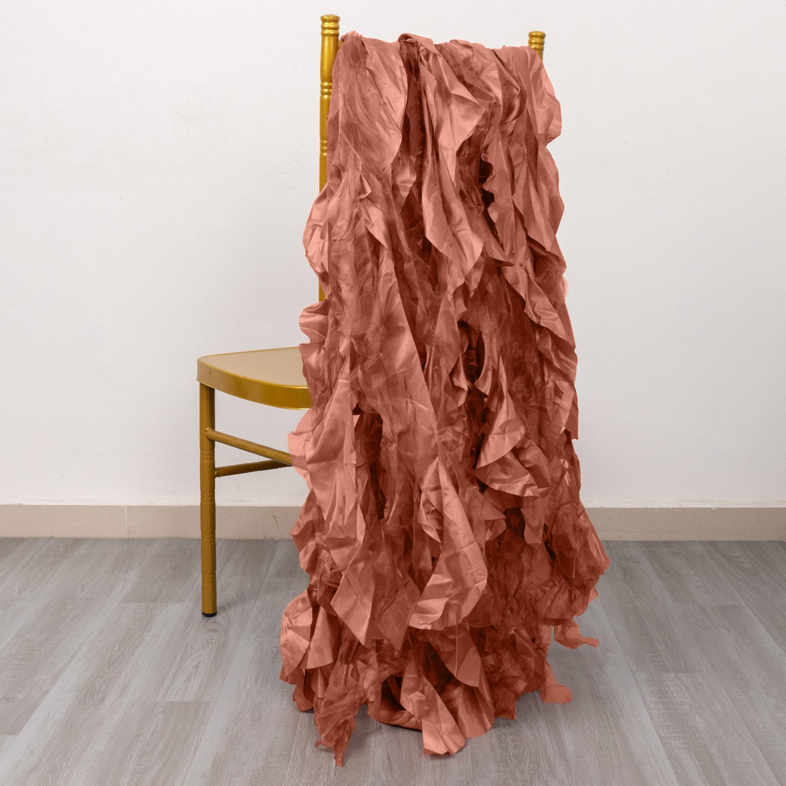 Terracotta curly willow chiffon satin chair sashes draped over a chair.
