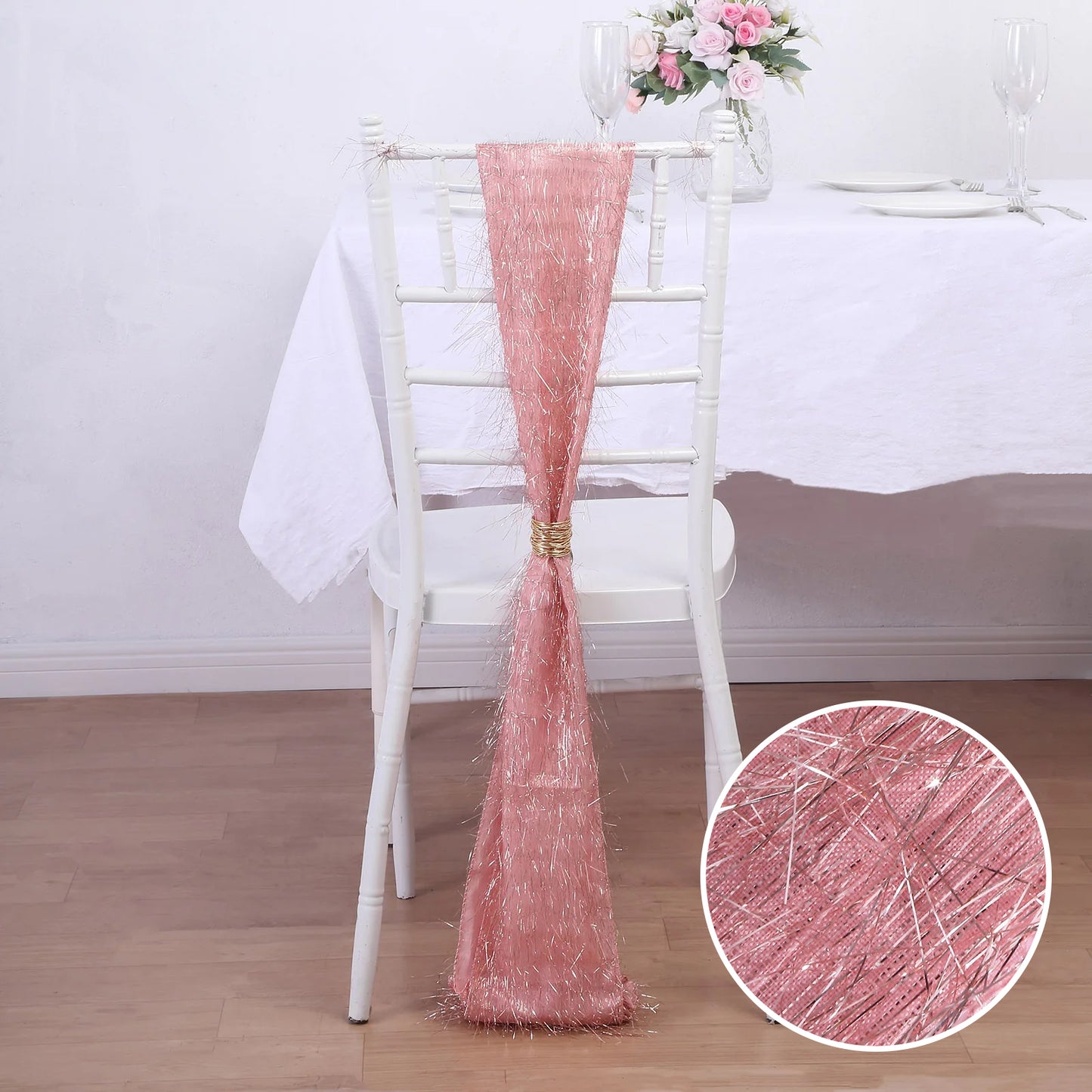Rose gold metallic fringe tinsel chair sash on a white chair.
