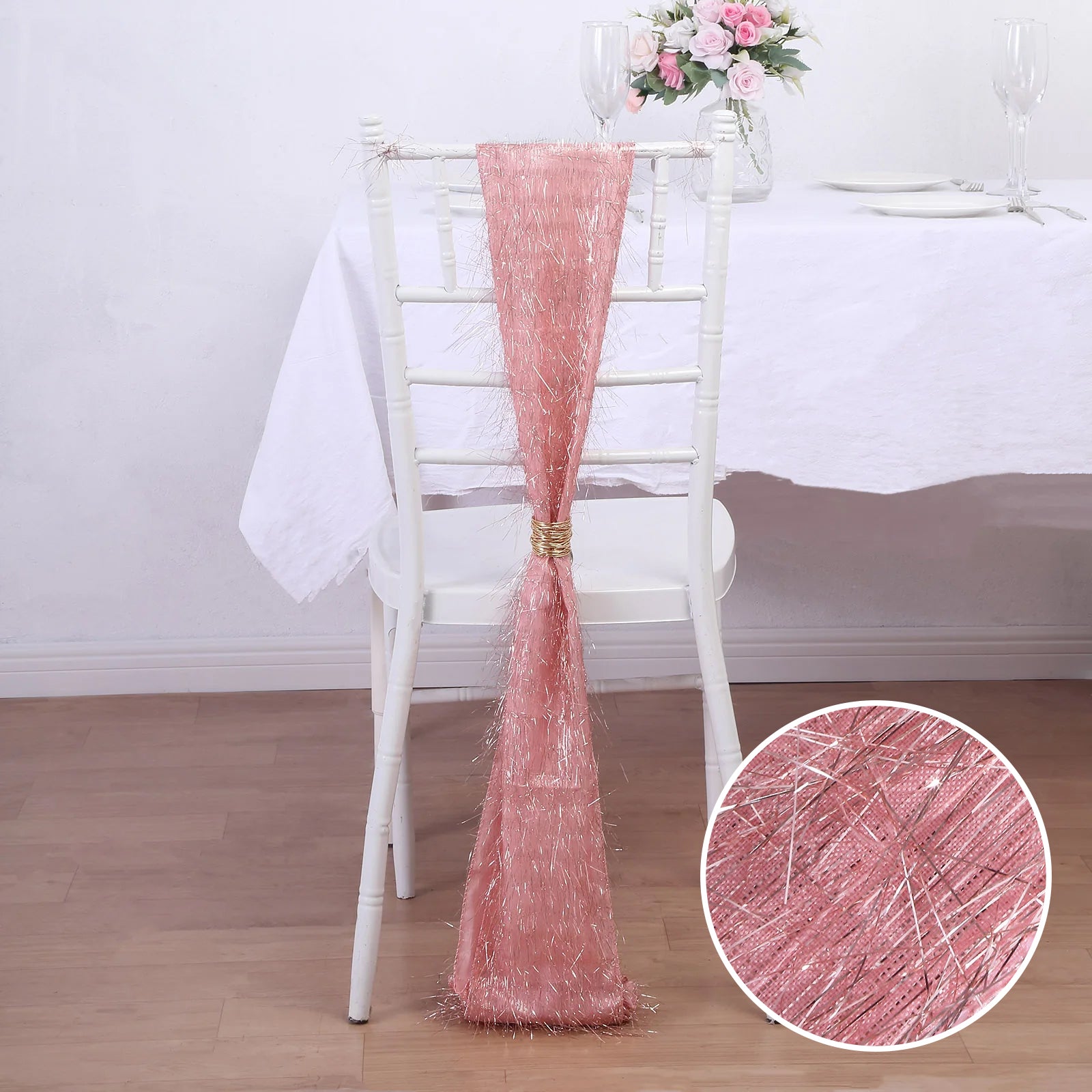 Rose gold metallic fringe tinsel chair sash on a white chair.