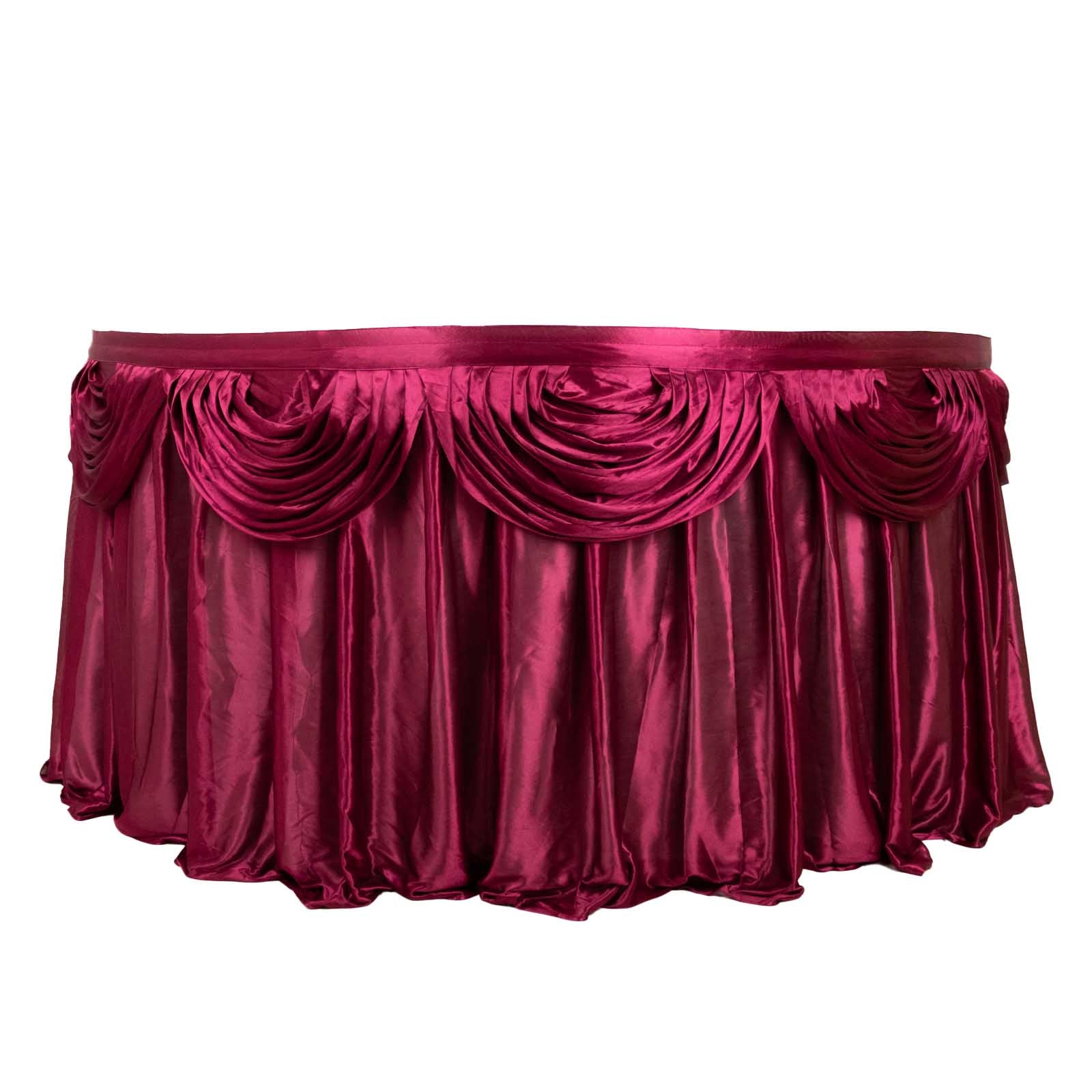Burgundy pleated satin table skirt draped elegantly for events.