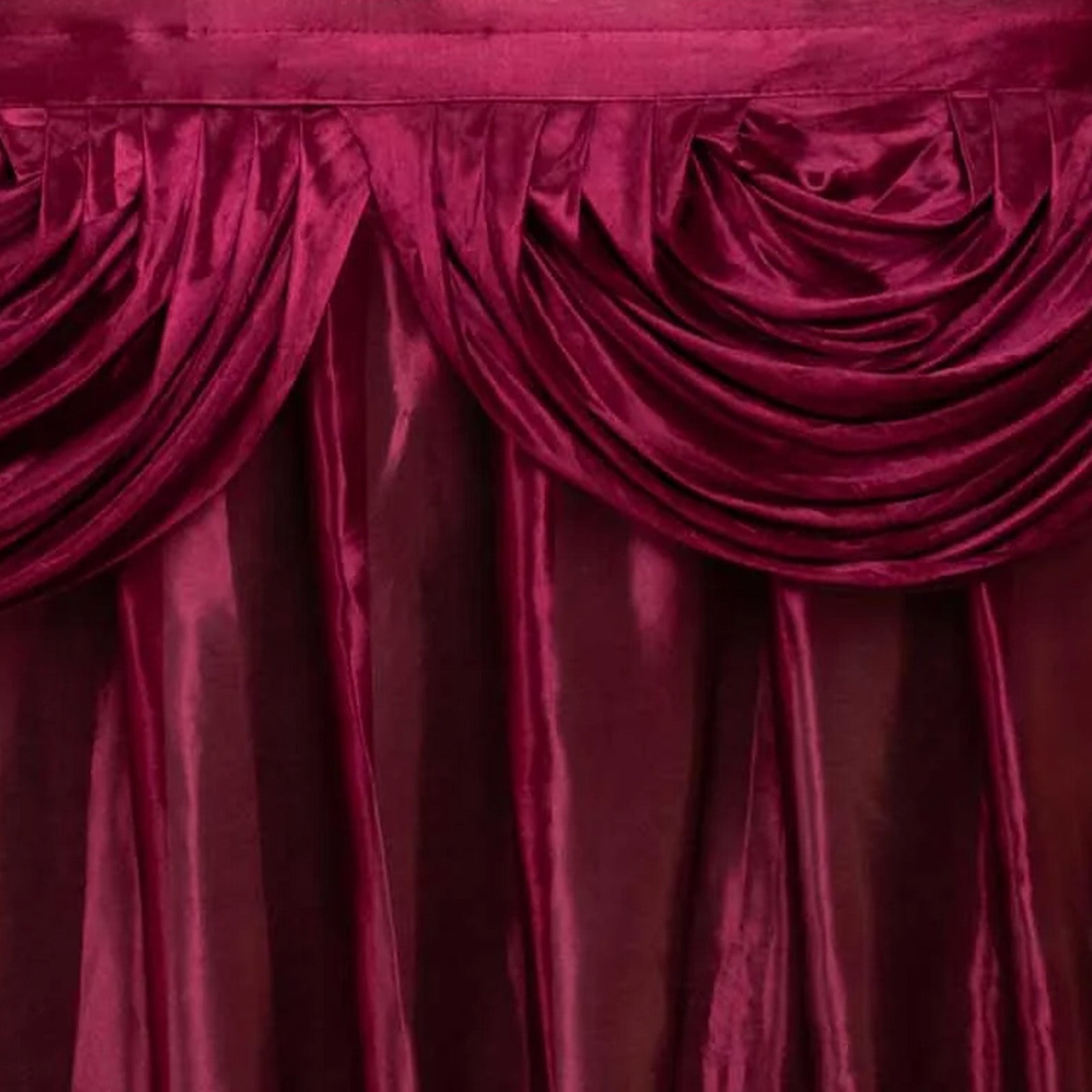 Burgundy pleated satin table skirt with double drape detailing. #whtbkgd