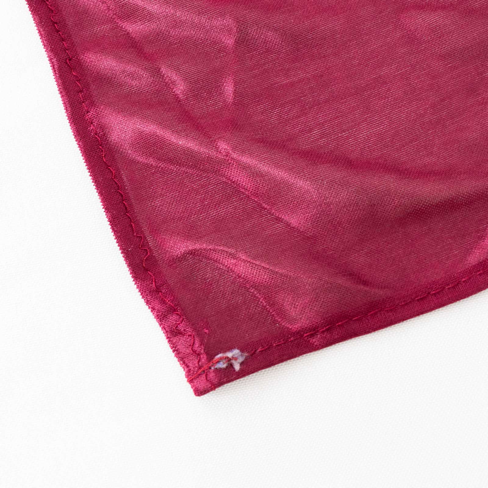 Burgundy pleated satin table skirt corner detail.