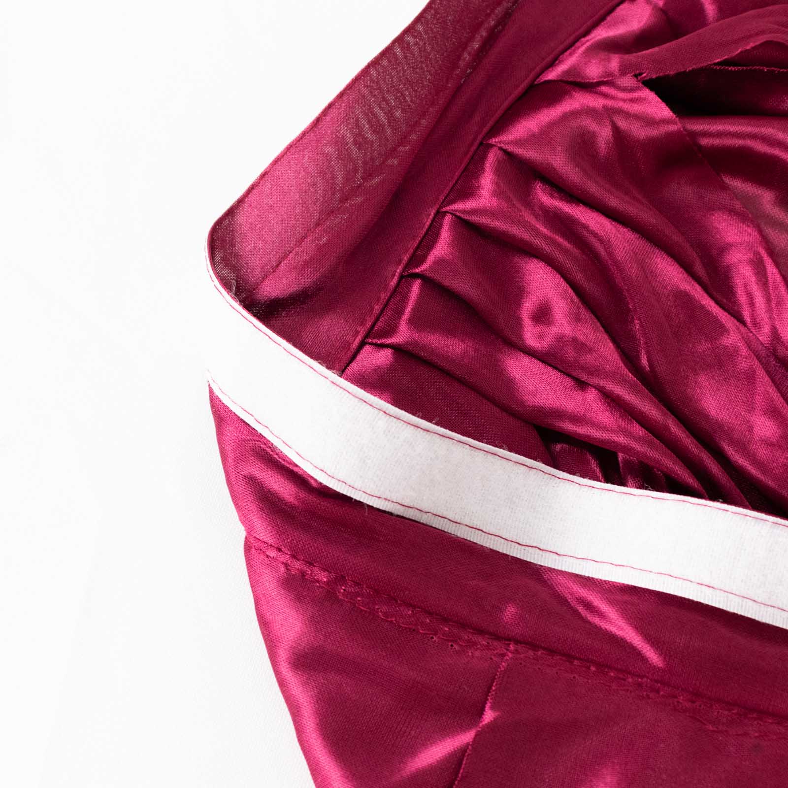 Burgundy pleated satin double drape table skirt.