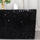 Black sequin table skirt with dual layers on a decorative table setting.