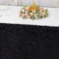 Black sequin satin table skirt with floral centerpiece.