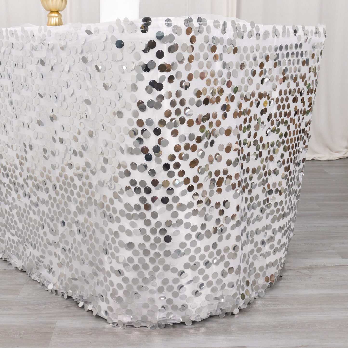 Silver sequin table skirt with dual-layered satin design, 21ft long.