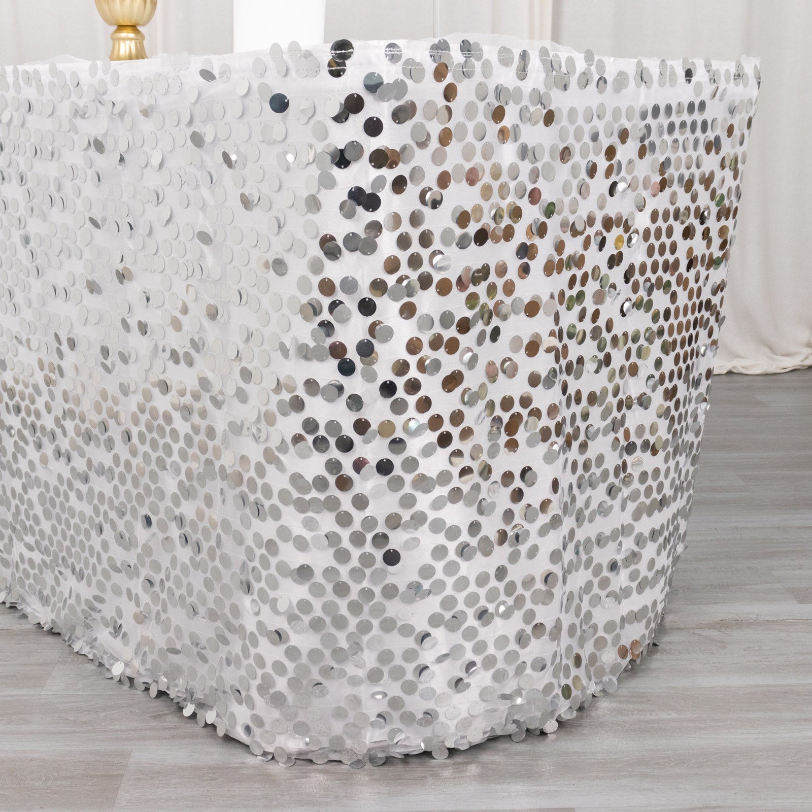 Silver sequin table skirt with dual-layered satin design, 21ft long.
