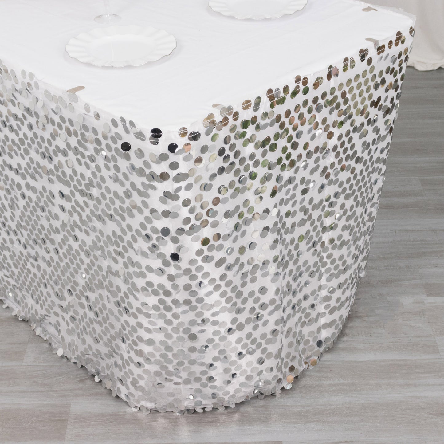 21ft silver sequin table skirt with dual layers on a white table.