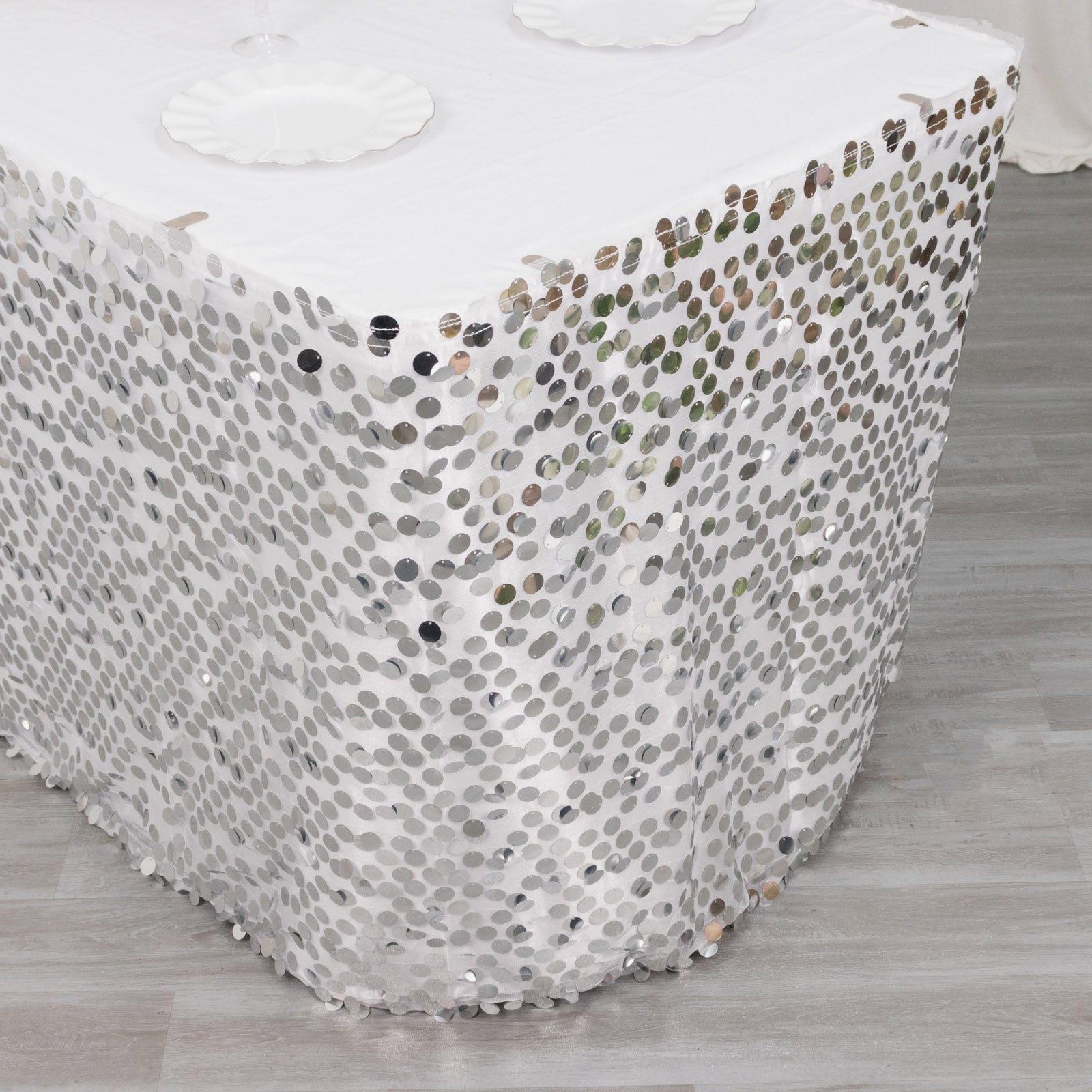 21ft silver sequin table skirt with dual layers on a white table.