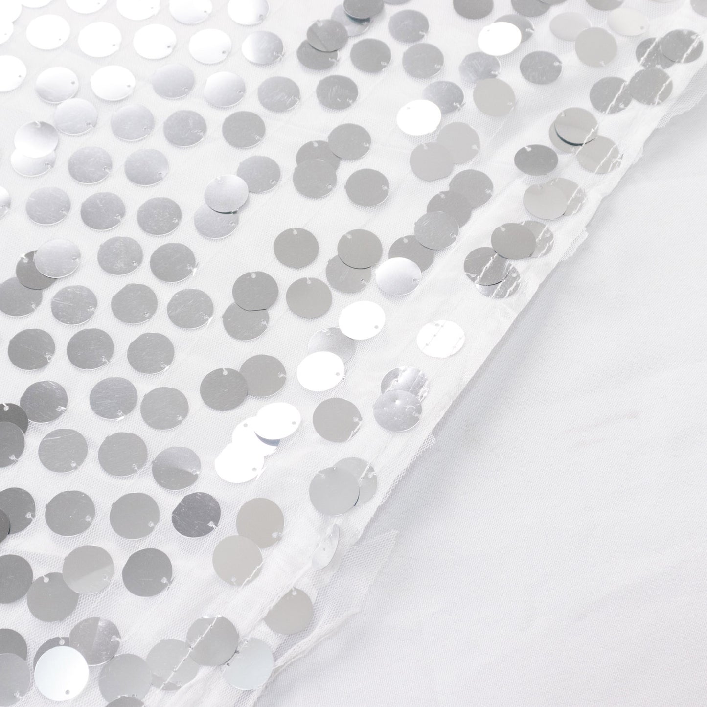 Silver sequin table skirt with dual-layered satin finish.