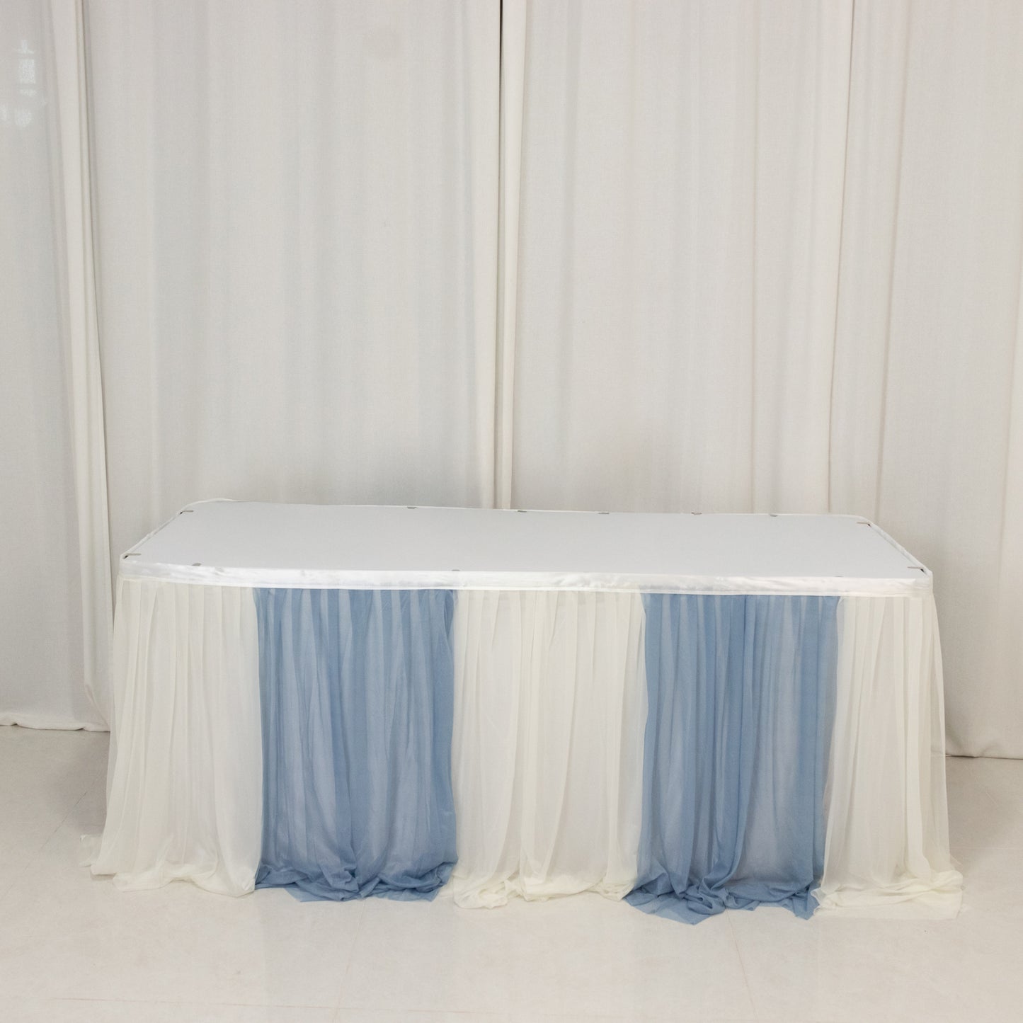 Dusty blue and white table skirt for elegant event decor.