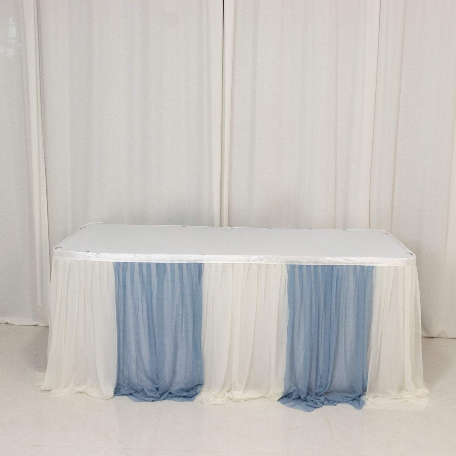 Dusty blue and white table skirt for elegant event decor.