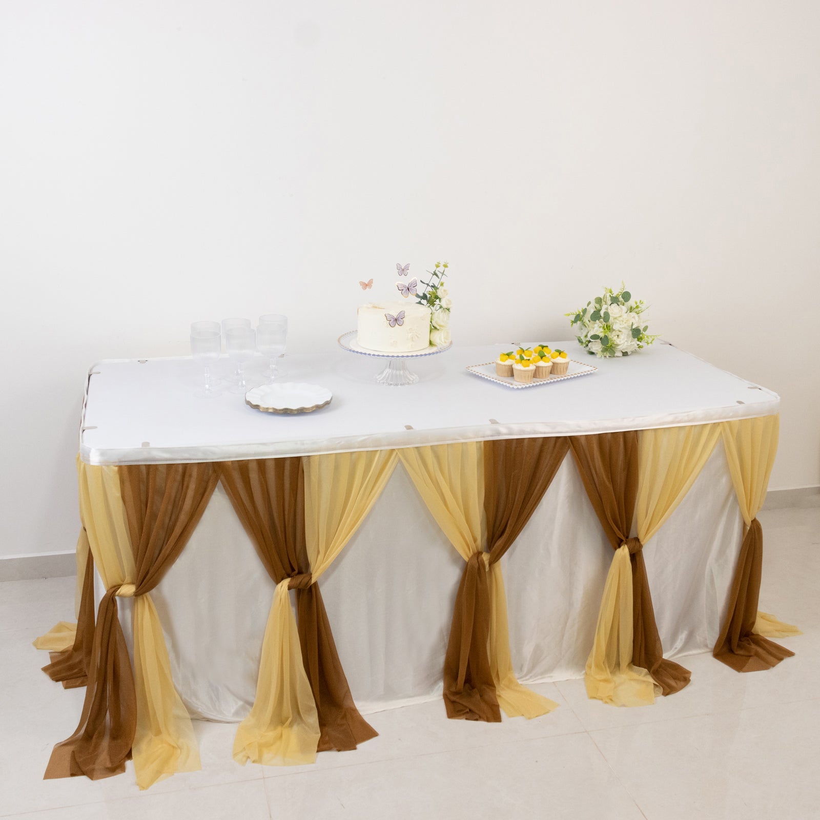 Elegant gold table decor with draped fabric