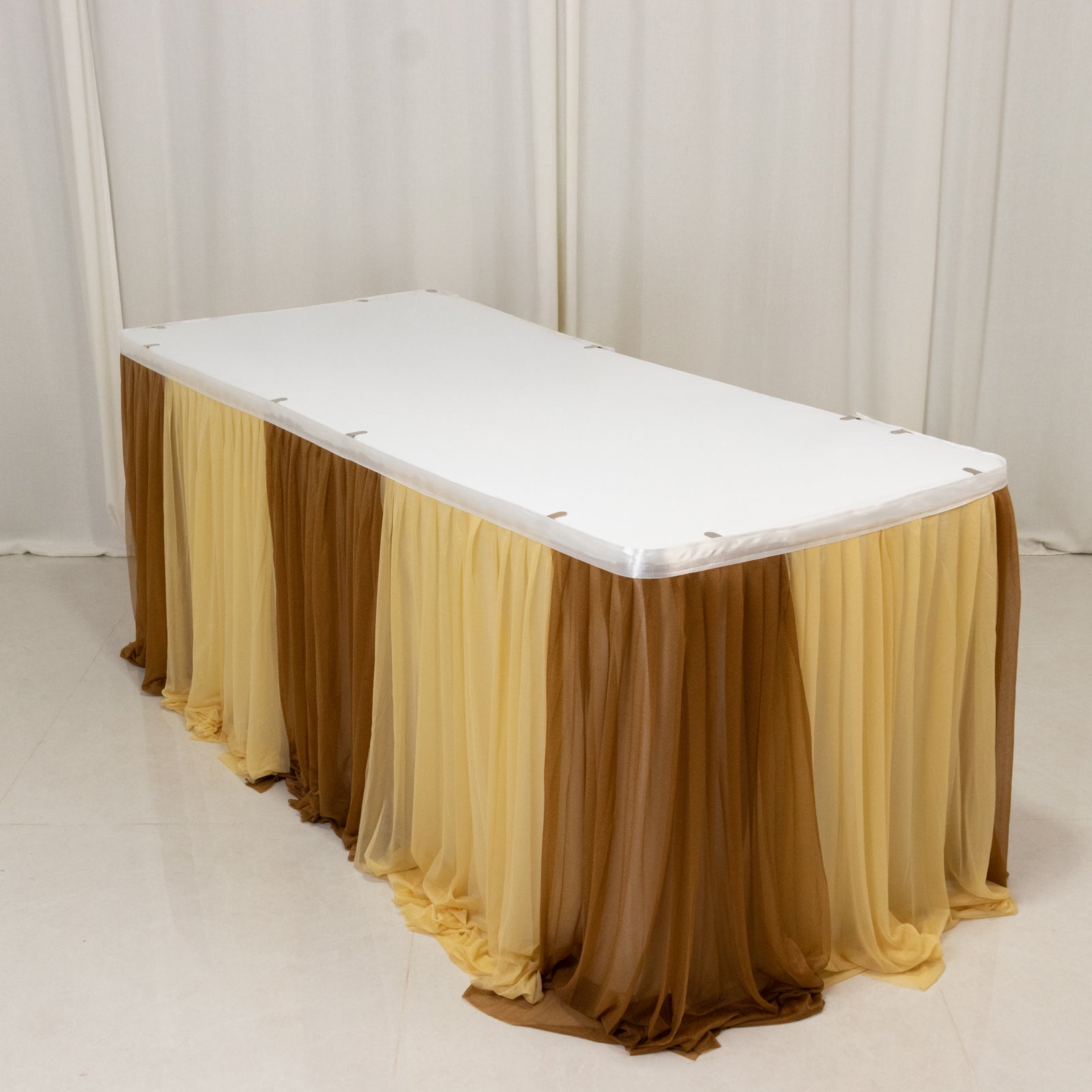 Gold table skirt with elegant layered design for events and decorations.