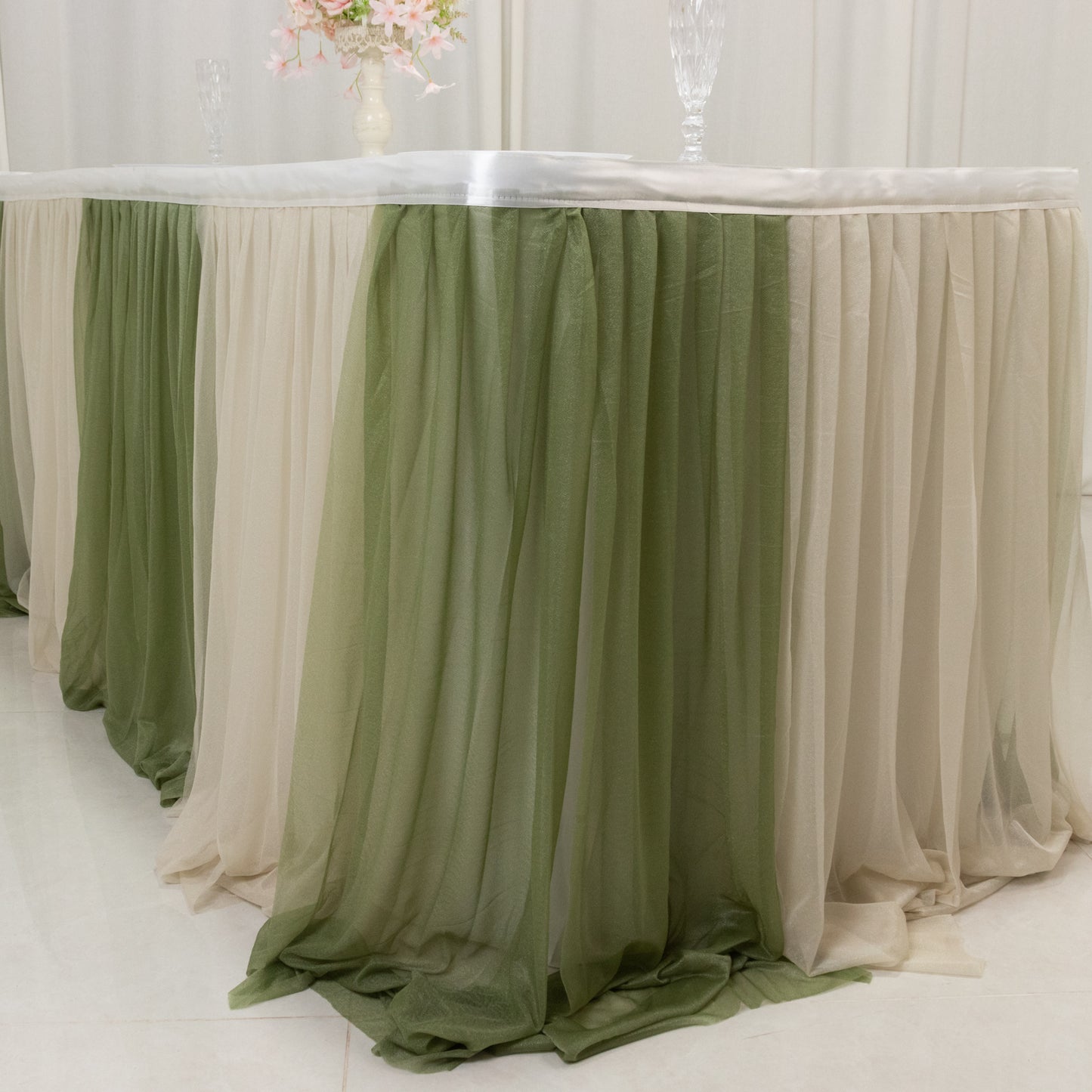 Dusty Sage table skirt with elegant draping for event decor.