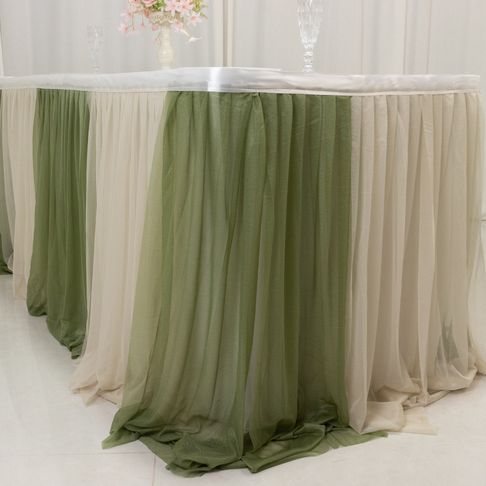 Dusty Sage table skirt with elegant draping for event decor.
