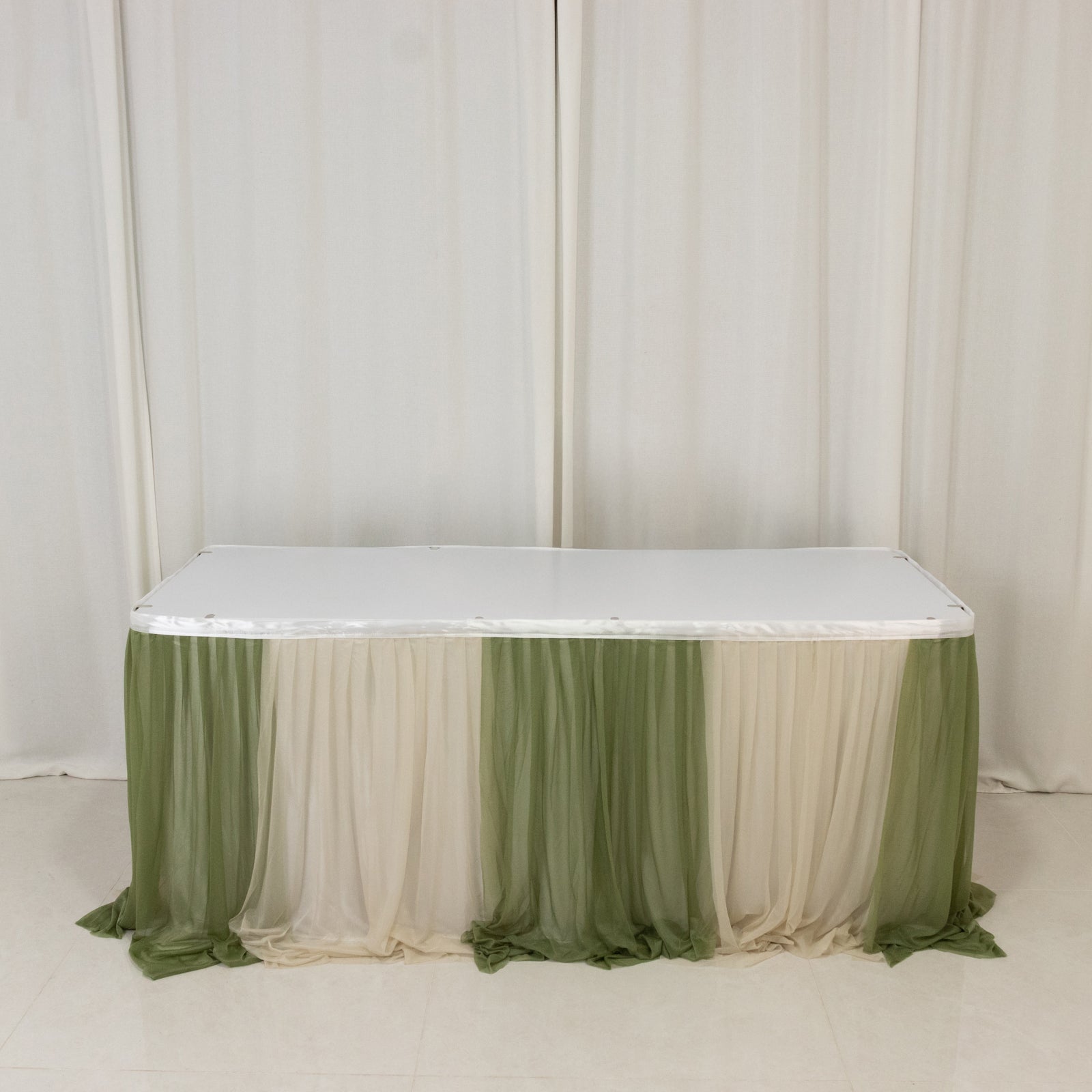 Elegant table draped in Dusty Sage fabric with soft cream accents.