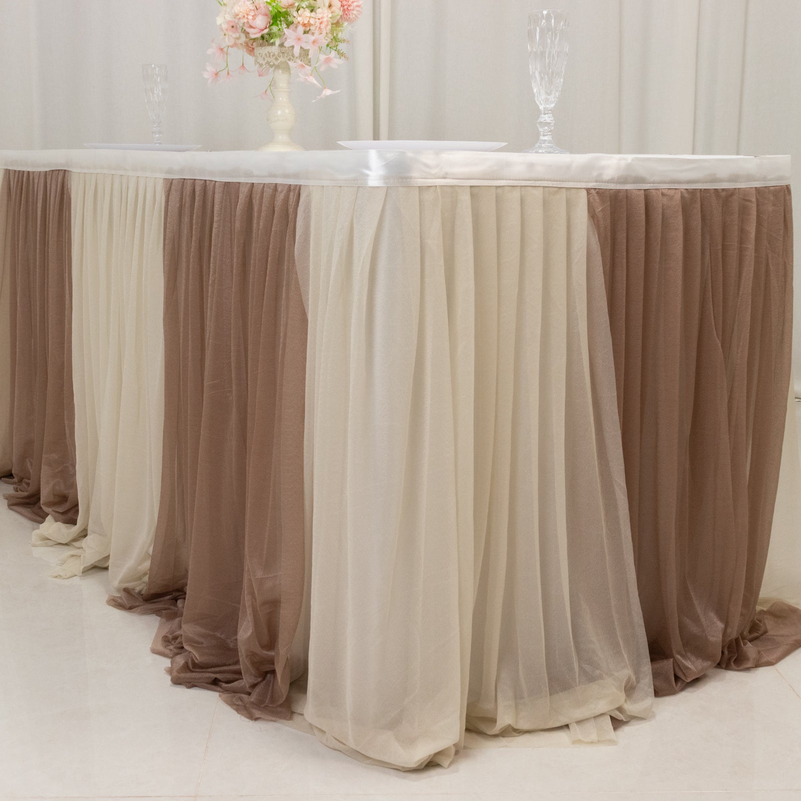 Beige table skirt draping for elegant events and decorations.