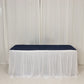 Elegant white table draping with a navy blue table runner for events.