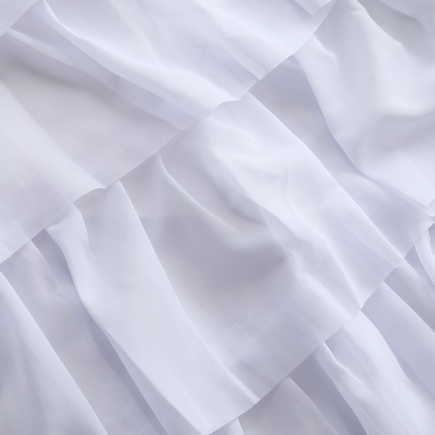 White sheer fabric with textured layers, perfect for elegant designs and décor.