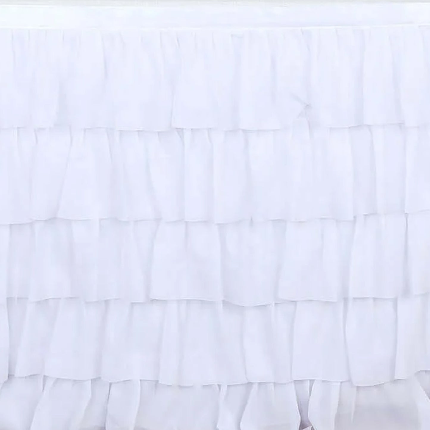 White ruffled table skirt for elegant decor and events. #whtbkgd
