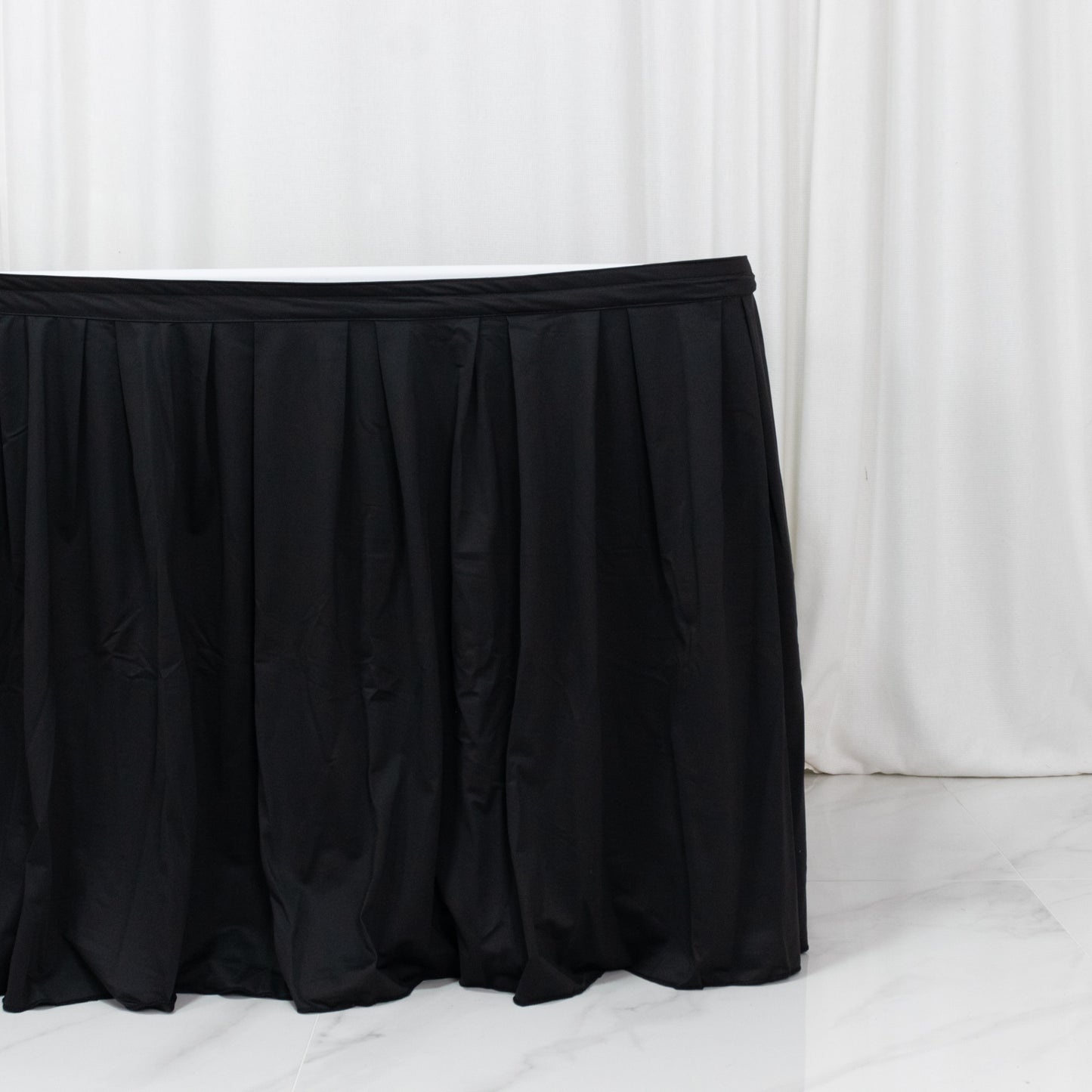 Black 17ft wrinkle-free event table skirt with shirred pleat design.