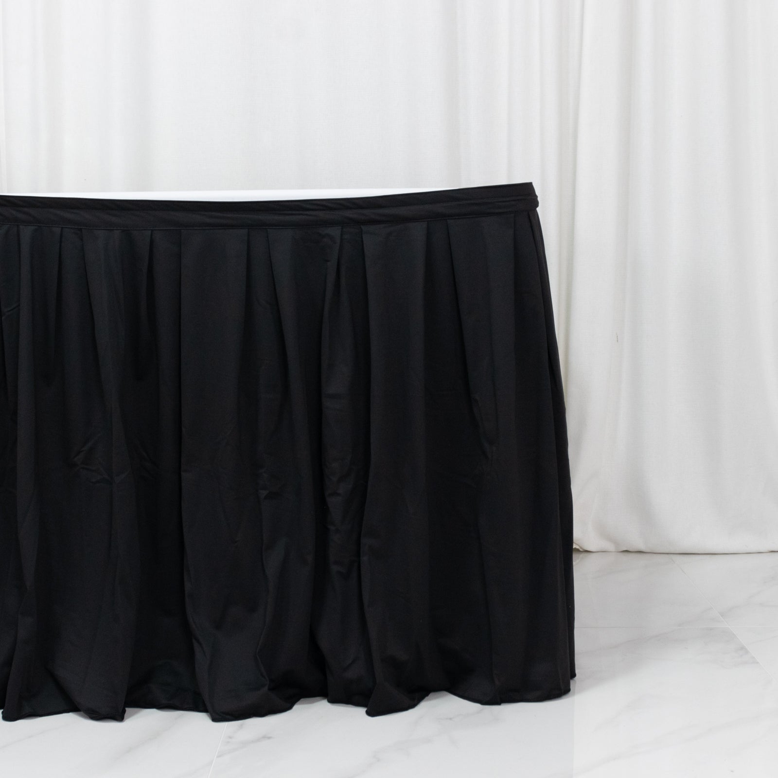 Black 17ft wrinkle-free event table skirt with shirred pleat design.
