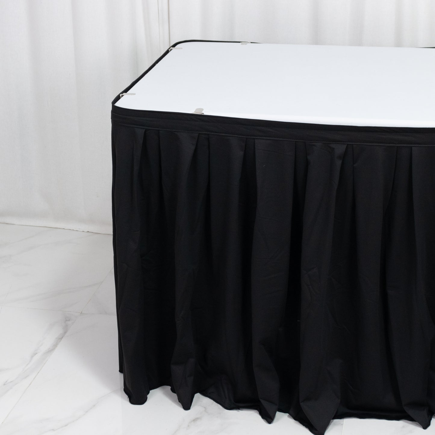 Black 17ft wrinkle-free and stain-resistant scuba table skirt for events.