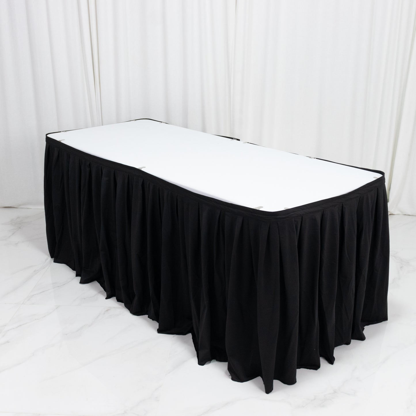 Black 17ft wrinkle-free and stain-resistant scuba table skirt for events.