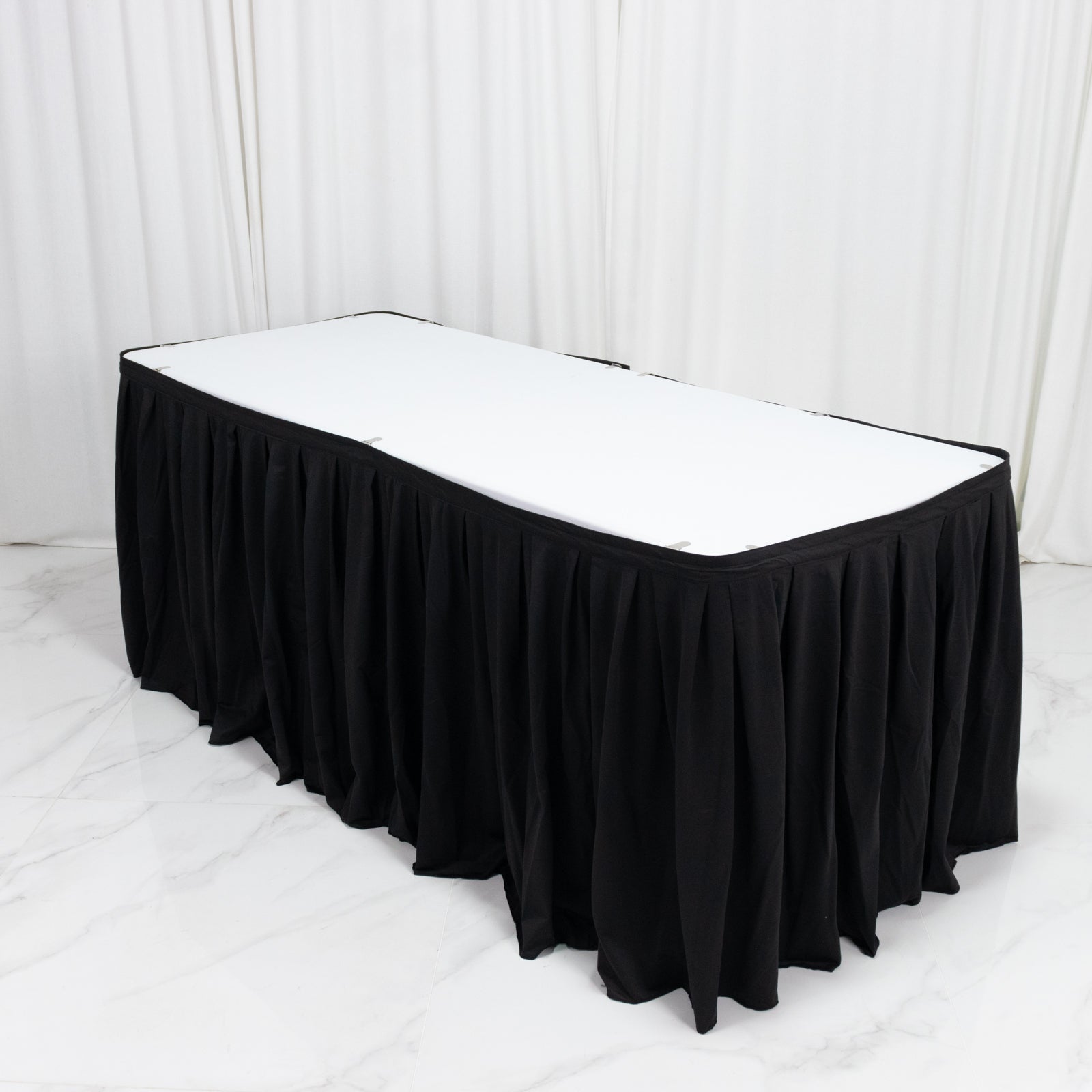 Black 17ft wrinkle-free and stain-resistant scuba table skirt for events.