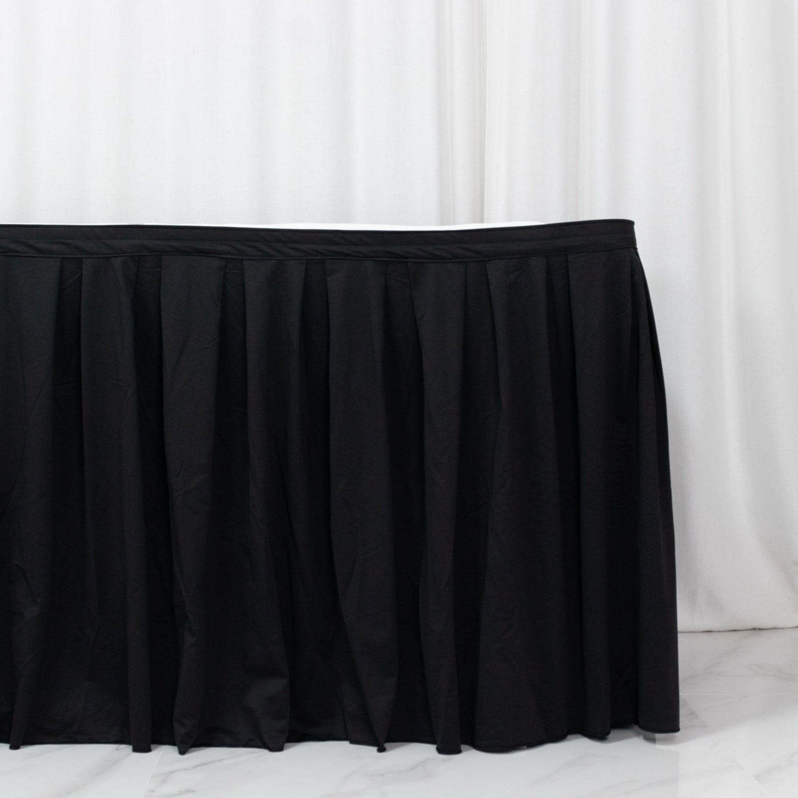 Black 21ft wrinkle-free scuba table skirt with shirred pleats.