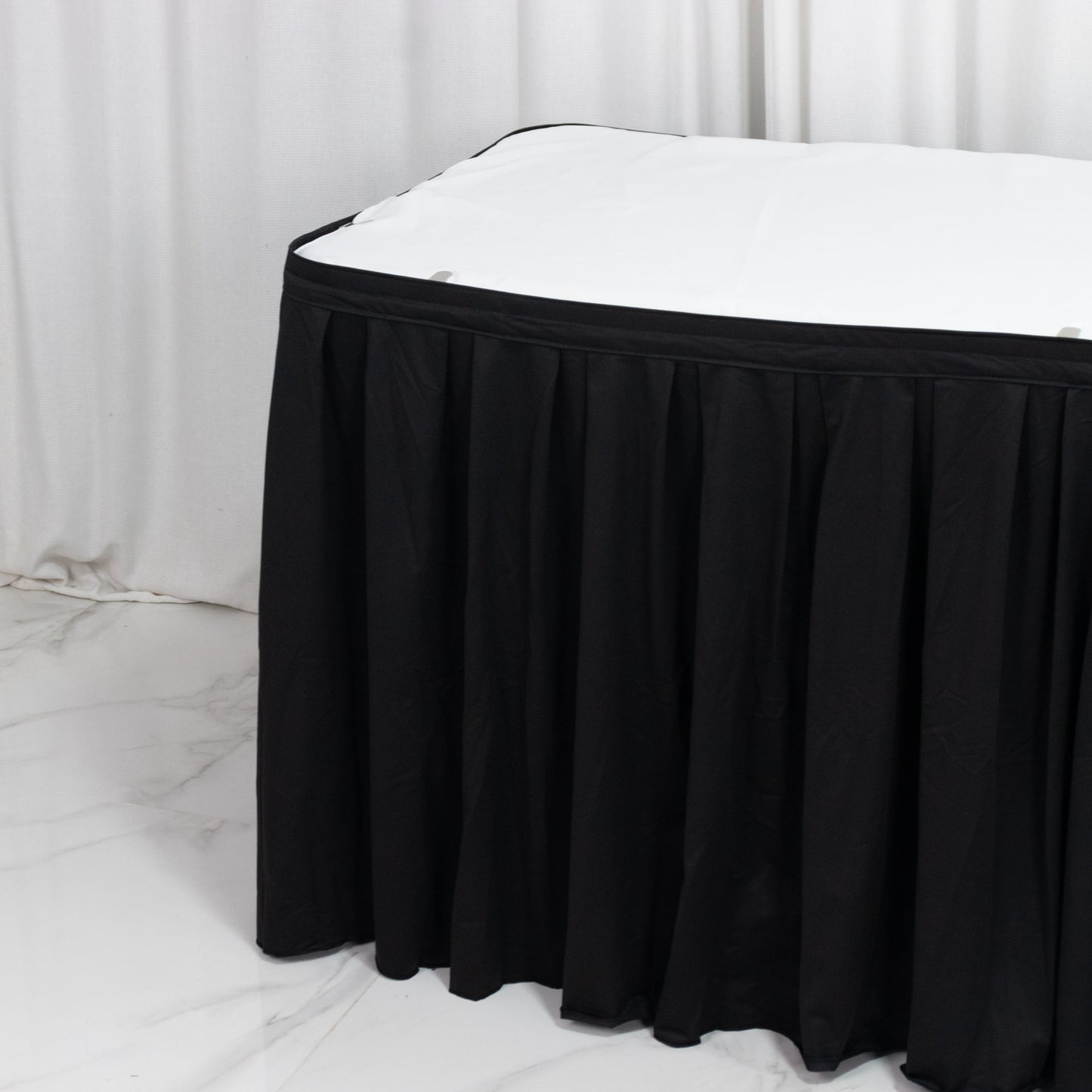 Black wrinkle-free and stain-resistant event table skirt.