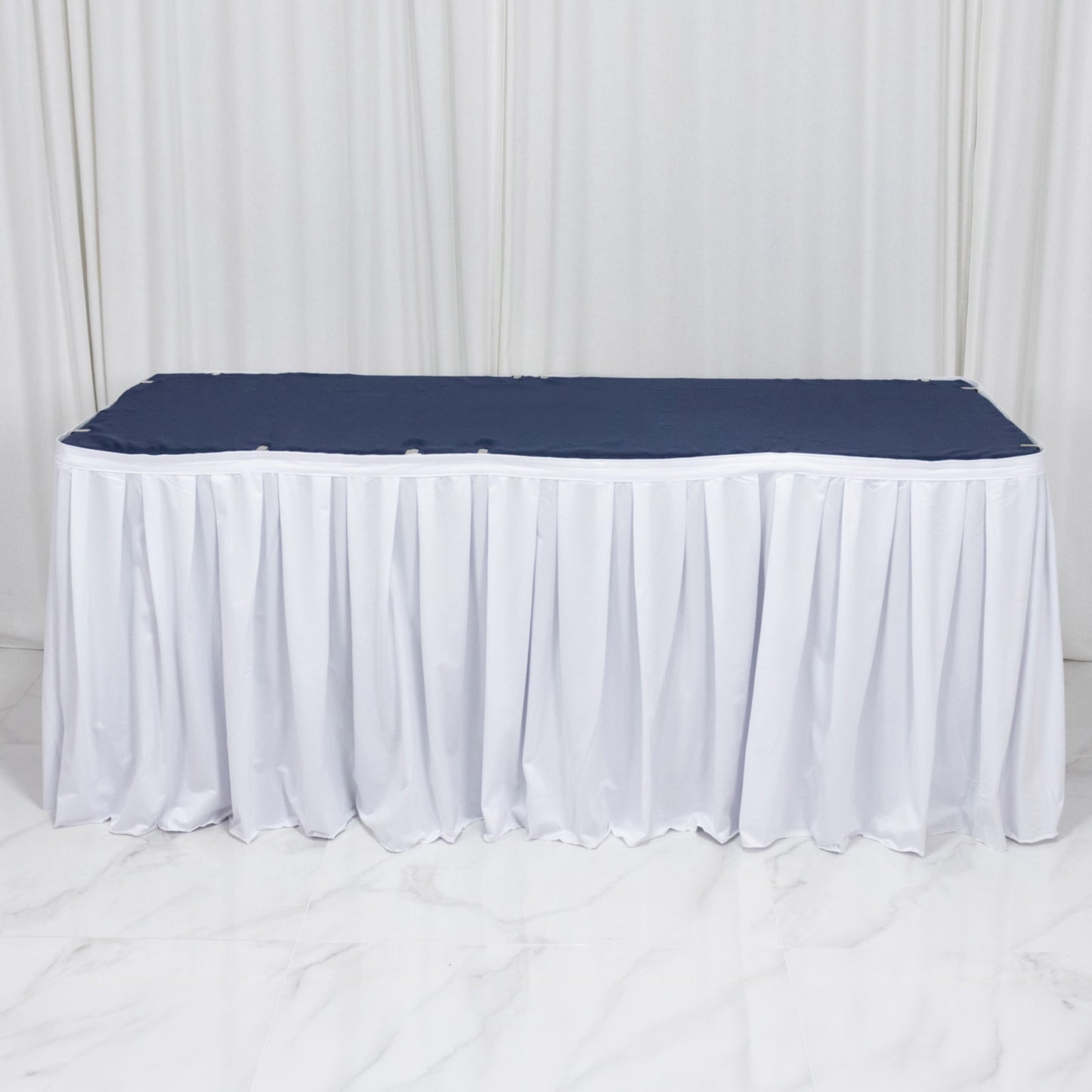 White shirred pleat table skirt for events, wrinkle-free and stain-resistant.