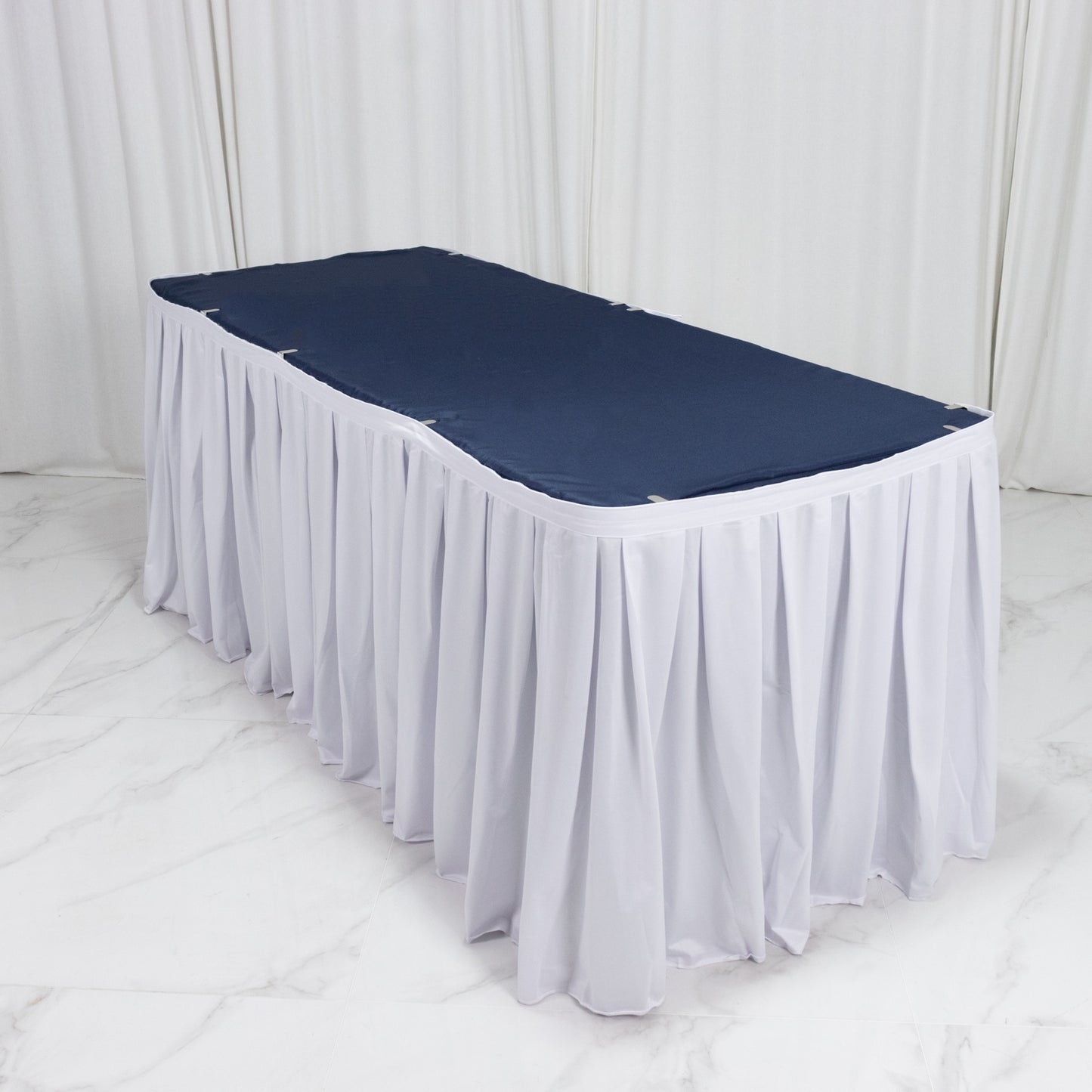 White scuba table skirt with shirred pleats for events.