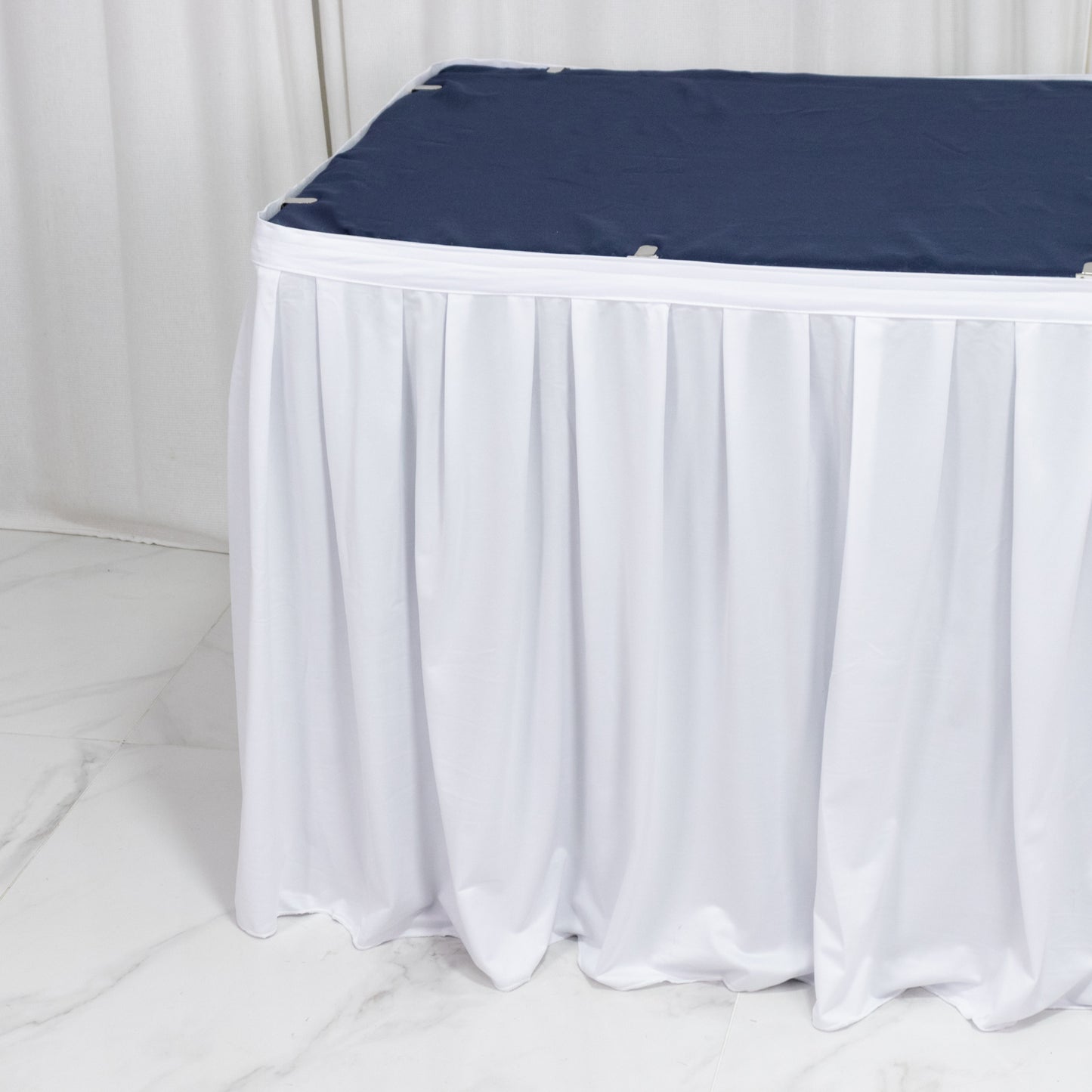 White 17ft scuba table skirt with shirred pleat, wrinkle-free and stain resistant.