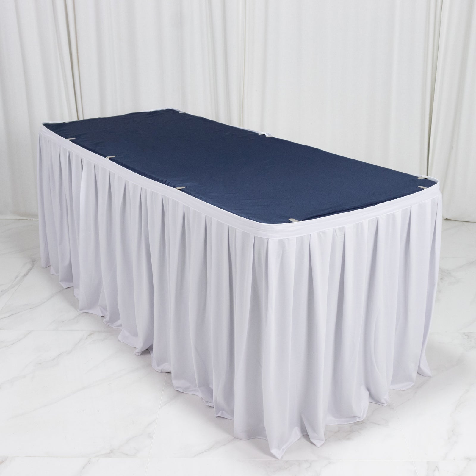 White 17ft wrinkle-free and stain-resistant scuba table skirt with shirred pleats.
