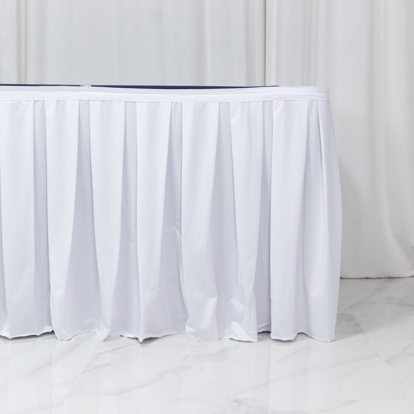 White shirred pleat table skirt for events, wrinkle-free and stain-resistant.