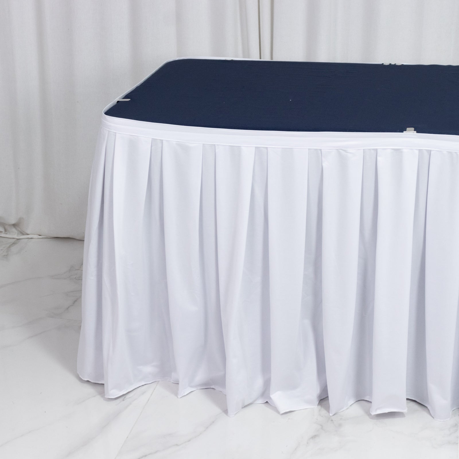 White scuba table skirt with shirred pleats, wrinkle-free and stain-resistant.