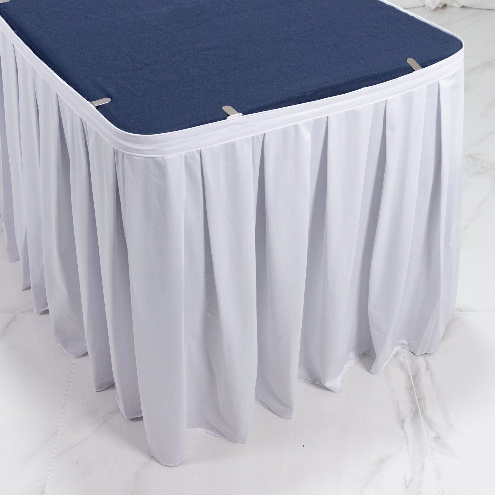 White shirred pleat table skirt for events, wrinkle-free and stain-resistant.
