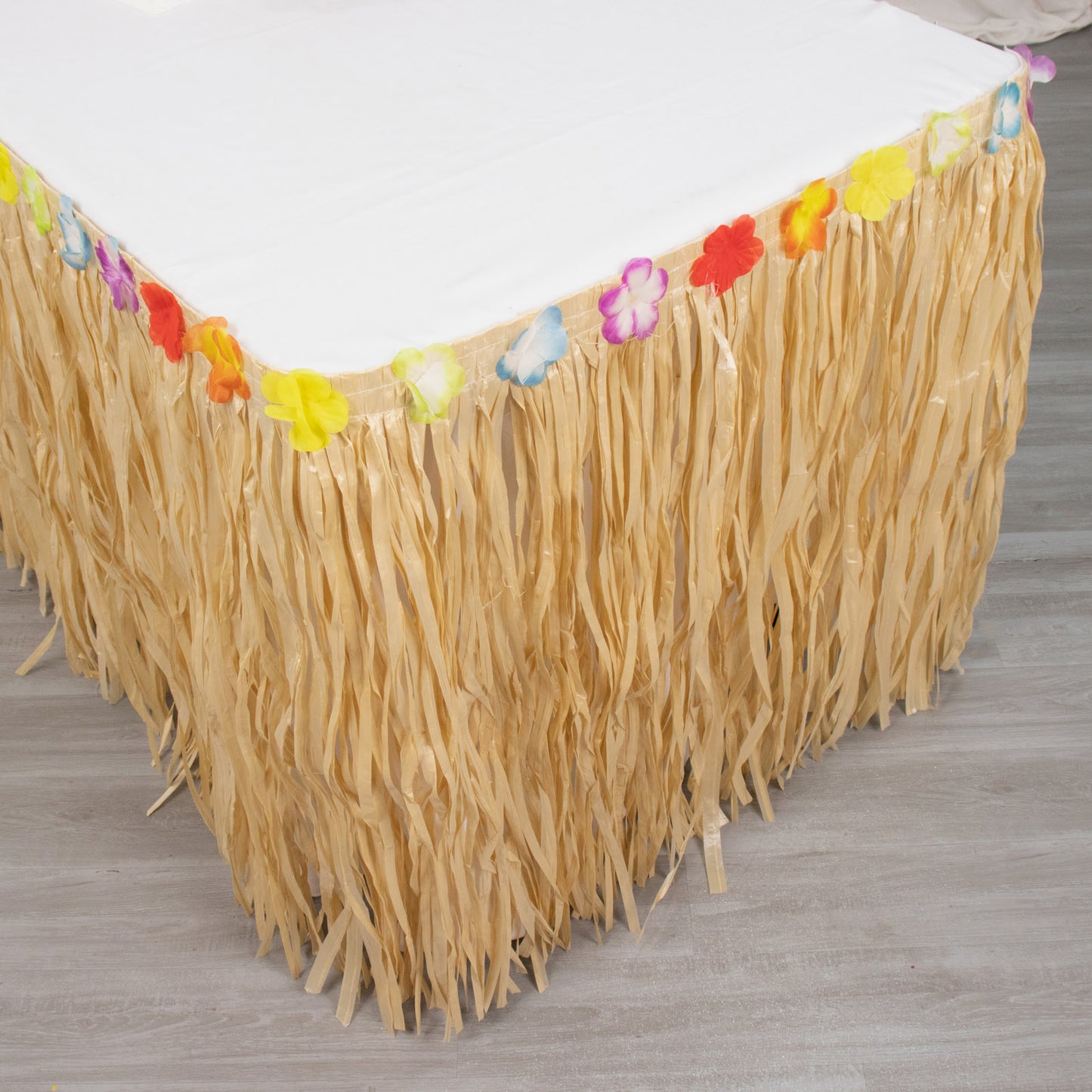 Natural raffia grass table skirt for luau party decorations.