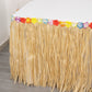 Natural raffia grass table skirt for luau decorations.