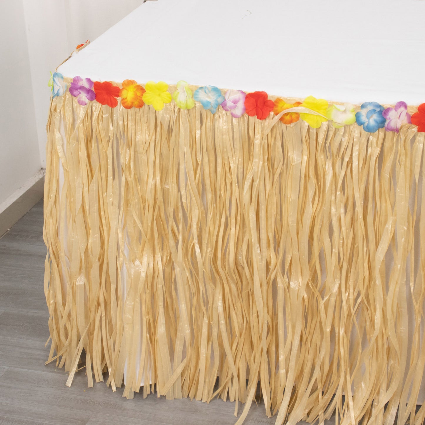 Natural raffia grass table skirt for luau decorations.
