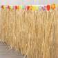 Natural raffia grass table skirt for Hawaiian themed party decorations.