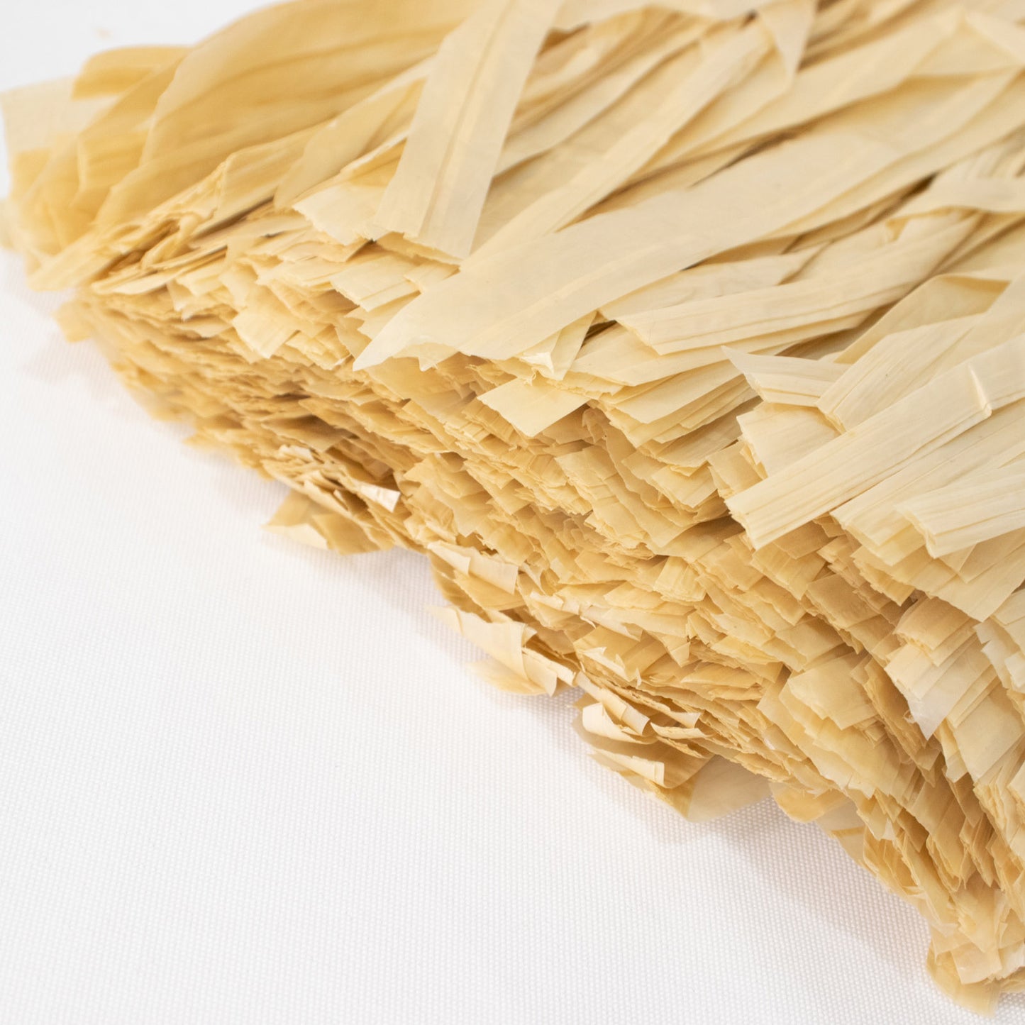 Natural raffia grass table skirt for Hawaiian themed parties.