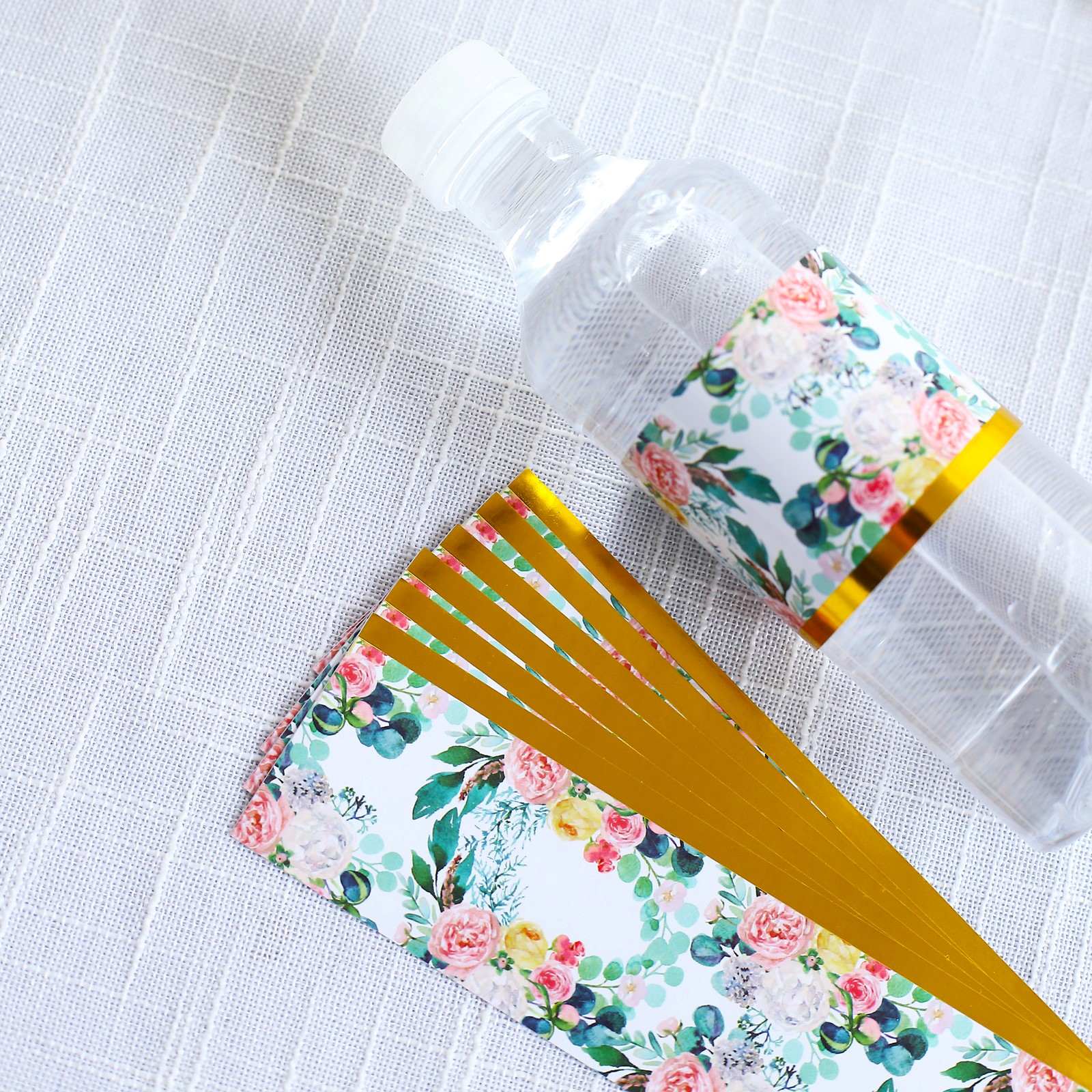 White and pink floral water bottle labels with gold trim.