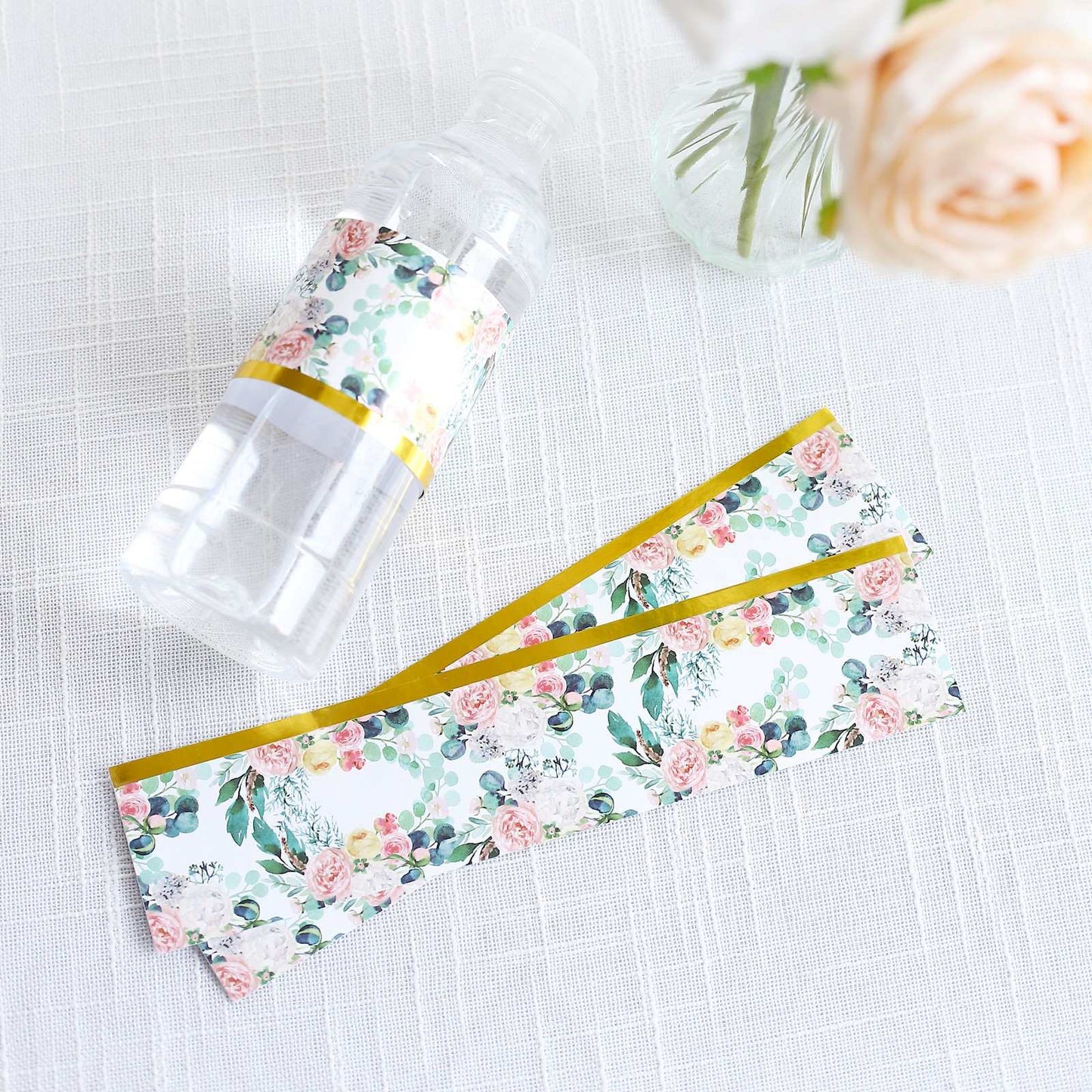 White and pink floral water bottle labels with gold trim.