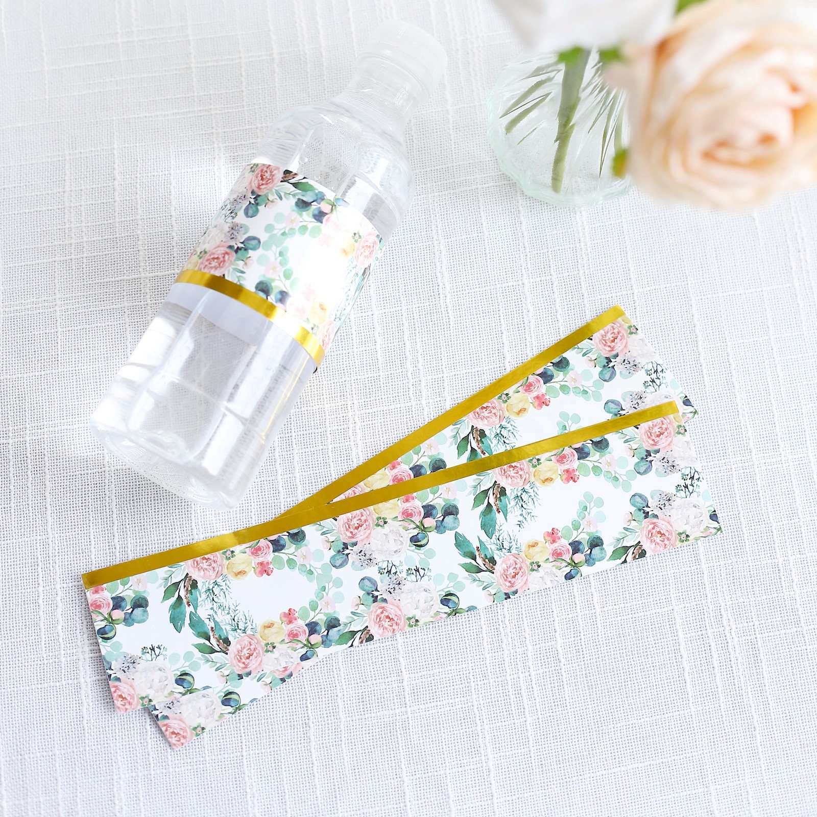 White and pink floral water bottle labels with gold trim.