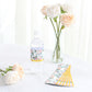 White and pink floral water bottle label with gold trim.