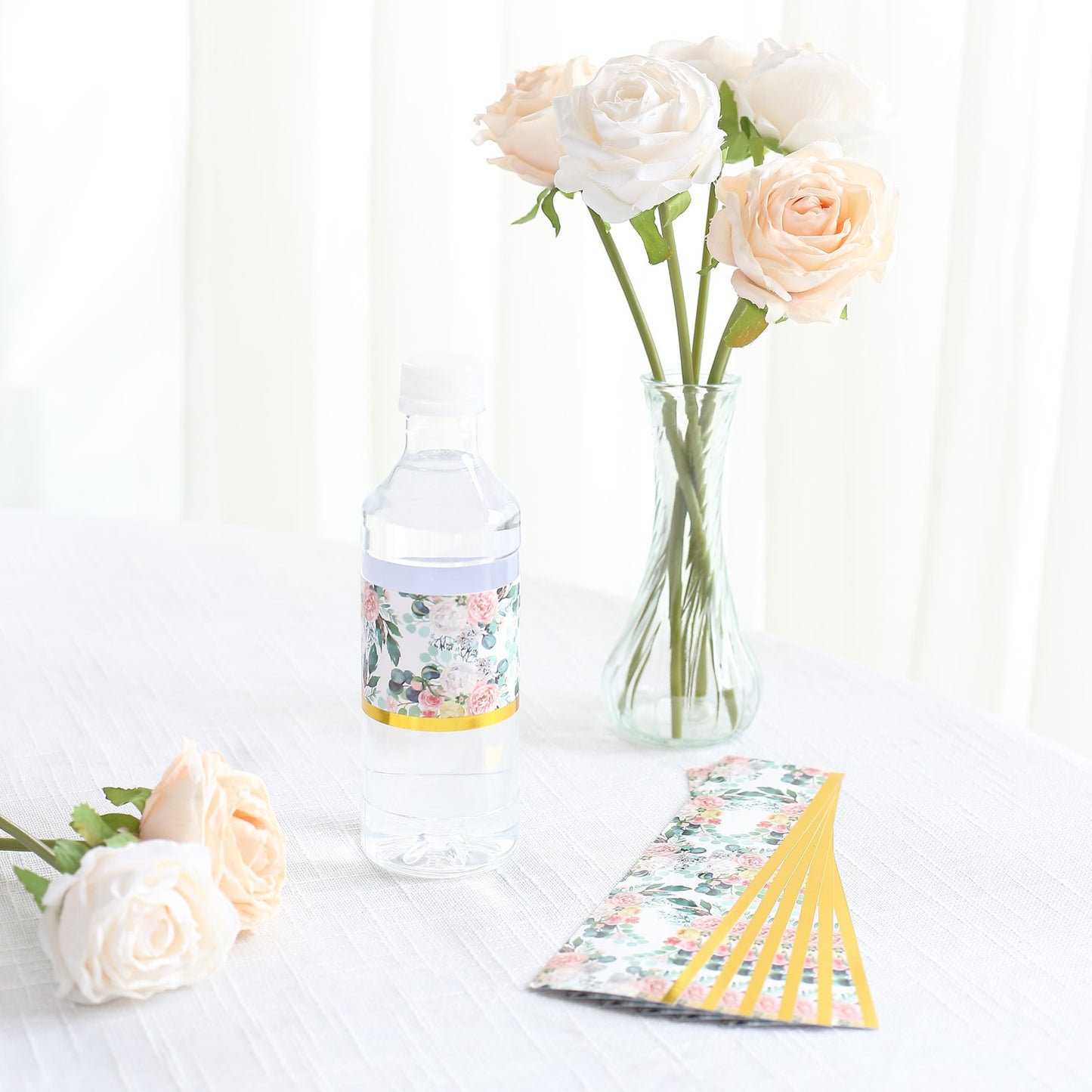 White and pink floral water bottle label with gold trim.
