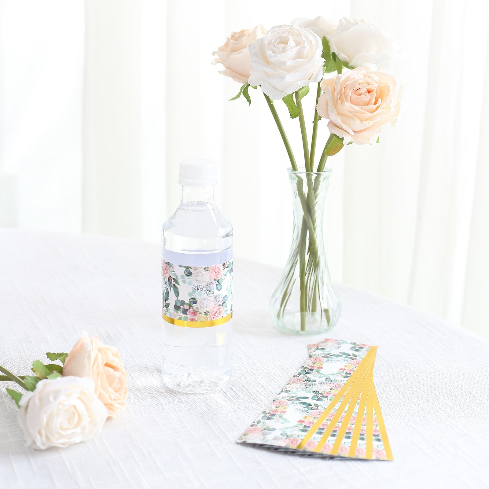 White and pink floral water bottle label with gold trim.